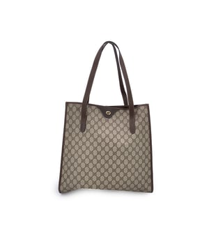 VINTAGE, RRP AS NEW
Step into the understated elegance of the past with this vintage Gucci tote bag, a refined piece from the iconic Gucci Accessory Collection. Crafted in beige monogram canvas, it proudly showcases the unmistakable GG pattern that defined an era of quiet luxury. Trimmed in rich brown genuine leather, this tote exudes both character and classic Italian craftsmanship.  The magnetic button closure opens to a beige fabric-lined interior, complete with a practical side zip pocket for your essentials. Inside, the original 'GUCCI Accessory Collection - Made in Italy' leather tag remains intact, a subtle nod to the brand's heritage and ity.  A timeless piece for those who appreciate vintage luxury with soul, this Gucci tote is more than a bag-it's a story carried on the arm. Condition Rating: B - VERY GOOD CONDITIONCondition Details: Gently used. Minimal wear of use on leather trim. A small white mark on canvas on the bottom. Please check the photos carefully and ask if you need to know more details or if you have any doubts.Measurements (cm):Depth: 11.4Height: 36.8Length: 36.8Other Details: Dustbag? NoKeys? NoBox? No Measurments:  width: 114 mm length: 368 mm height: 368 mm strap length: 0 mm handle drop: 0 mm