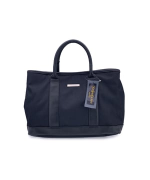 VINTAGE, RRP AS NEW
Understated, refined, and undeniably rare, this Vintage Yves Saint Laurent Pour Homme tote captures the quiet confidence of YSL's menswear line in a form that still feels effortlessly modern. Crafted from durable black nylon canvas and accented with sleek black leather trim, this tote is a functional piece with subtle designer distinction.  At the front, a silver metal Yves Saint Laurent tab adds a discreet touch of luxury, while the magnetic button closure opens to reveal a black nylon canvas lining-clean, simple, and timeless. Inside, a zip pocket offers secure storage, and the original 'Yves Saint Laurent' tag affirms the bag's ity. A true collector's bonus: the 'Yves Saint Laurent Pour Homme' shop hang tag remains thoughtfully attached, hinting at the bag's pristine and possibly unused Condition Rating: A - EXCELLENTCondition Details: Gently used. Yves Saint Laurent hang tag still attached. Please check the photos carefully and ask if you need to know more details or if you have any doubts.Measurements (cm):Depth: 15.2Height: 24.1Length: 35.6Other Details: Dustbag? NoKeys? NoBox? No Measurments:  width: 152 mm length: 356 mm height: 241 mm strap length: 0 mm handle drop: 0 mm
