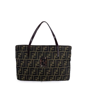 VINTAGE, RRP AS NEW
A true icon of Italian luxury, this Fendi tote bag is a love letter to the era when the Zucca monogram canvas ruled the fashion scene - and still turns heads today. Crafted with Fendi's signature attention to detail, the bag features rich brown genuine leather shoulder straps, offering a comfortable carry and a refined contrast to the classic monogram.  Front and center, a silver metal cut-out FF logo makes a bold, unmistakable statement - sleek, sculptural, and unmistakably Fendi. The front pocket, secured with a magnetic button closure, adds both function and style, while the top zipper keeps your essentials safe inside.  Open it up and you'll find a brown canvas lining, a side zip pocket for easy organization, and the discreet 'Fendi - Made in Italy' tag stitched inside. The serial number embossed within is the final mark of ity - a quiet assurance that you're holding the real deal.  Spacious, structured, and undeniably chic, this Fendi tote is more than a bag - it's a slice of fashion history, built to last and ready to be loved again. Condition Rating: A - EXCELLENTCondition Details: Gently used. Light darkness on the hardware. Some light wear of use on leather handles. Please check the photos carefully and ask if you need to know more details or if you have any doubts.Measurements (cm):Depth: 6.4Height: 19.1Length: 30.5Other Details: Dustbag? NoKeys? NoBox? No Measurments:  width: 64 mm length: 305 mm height: 191 mm strap length: 0 mm handle drop: 0 mm
