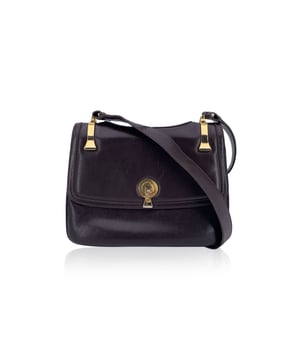 VINTAGE, RRP AS NEW
A classic from Gucci's rich leather-making legacy, this vintage brown leather shoulder bag is a quiet nod to Italian elegance. Crafted in smooth, warm-toned leather that has only grown more beautiful with time, it carries the character of decades past - where form met function with impeccable style.  The front flap features a sleek clasp closure, opening to a thoughtfully designed interior lined in matching brown leather. Inside, you'll find two main compartments, alongside a side zip pocket and a side open pocket - ideal for keeping essentials organized while on the move.  The adjustable leather shoulder strap allows for comfortable wear, whether slung casually or carried with intention. Stamped inside with 'Made in Italy by Gucci', this piece bears the unmistakable signature of quality and heritage.  Understated, refined, and deeply rooted in Gucci tradition, this shoulder bag is a timeless companion for lovers of vintage with an eye for craftsmanship. Condition Rating: B - VERY GOOD CONDITIONCondition Details: Some normal wear of use on leather (light scratches). Some light loss of gilding on the hardware. Some scratches on the internal lining. Please check the photos carefully and ask if you need to know more details or if you have any doubtsMeasurements (cm):Depth: 3.8Height: 19.1Length: 25.4Other Details: Dustbag? NoKeys? NoBox? No Measurments:  width: 38 mm length: 254 mm height: 191 mm strap length: 0 mm handle drop: 0 mm