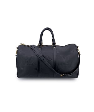 VINTAGE, RRP AS NEW
This beautiful Bag will come with a Certificate of ity provided by Entrupy. The certificate will be provided at no further cost.  Effortlessly blending heritage and modern luxury, the Louis Vuitton Keepall Bandoulière 45 in Monogram Empreinte Géant leather is the ultimate travel companion for those who appreciate refined detail and timeless design. This version of the iconic Keepall is crafted in deep black grained leather embossed with an oversized monogram-bold yet understated, and unmistakably Louis Vuitton.  Accented with gold-tone hardware, the bag features rounded leather handles, an adjustable and removable black leather shoulder strap, and a classic leather name tag-a nod to the golden age of travel. The double zip opens to a saffron microfiber-lined interior, complete with a side zip pocket and D-ring for securing smaller items.  Finished with 'LOUIS VUITTON Paris - Made in Italy' discreetly stamped on the bottom leather trim, this piece carries all the hallmarks of luxury craftsmanship. With a current retail value of €3,000, the Keepall Bandoulière 45 remains an enduring icon-reimagined here in a sleek, monochrome palette for the modern voyager with a taste for elevated essentials. Condition Rating: A - EXCELLENTCondition Details: Gently used. The padlock and keys are not included. Please check the photos carefully and ask if you need to know more details or if you have any doubts.Measurements (cm):Depth: 20.3Height: 25.4Length: 45.7Other Details: Dustbag? NoKeys? NoBox? No Measurments:  width: 203 mm length: 457 mm height: 254 mm strap length: 0 mm handle drop: 0 mm