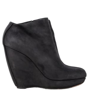 VINTAGE, RRP AS NEW
 Command attention with the Balenciaga Wedge Ankle Boots in black suede, merging sleek sophistication with architectural edge. The sculptural wedge heel and soft suede finish create a bold yet refined silhouette perfect for day-to-night wear. **Style Tip:** Style them with a midi skirt and structured blazer for a chic, contemporary twist on classic tailoring.

Balenciaga Wedge Ankle Boots in Black Suede

Condition: Good
Signs of wear: Moderate signs of wear or markings, moderate scuffing insoles., Used but well maintained. Moderate creasing and marks at surface, wear at soles or replaced soles.
Packaging: None
Color: Black
Material: Suede | suede
Size: IT | 38.5
Measurements: Heel height: 125; Insole length: 255
SKU: BAPUGBSH508323W