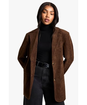 Oversized faux suede blazer with vintage-inspired finish
        Relaxed silhouette with structured notched lapels
        Button-front fastening for versatile styling options
        Long sleeves with subtle padding at shoulders
        Fully lined for comfortable wear and smooth draping
    
    This relaxed blazer in faux suede brings vintage charm to contemporary wardrobes. The oversized fit creates a nonchalant silhouette that works brilliantly for casual occasions whilst maintaining a refined edge. Style as seen with a sleek turtleneck and wide-leg trousers for family gatherings, or throw over a striped jumper with your favourite denim for weekend brunches. The textured finish adds depth to your ensemble without overwhelming it. For cooler days, layer over knitwear and pair with trainers for an effortlessly cool look. This versatile piece transitions seamlessly from daytime casual to evening drinks - simply swap your accessories and footwear to suit the occasion. A true wardrobe staple that combines comfort with Boohoo's signature trend-forward approach.