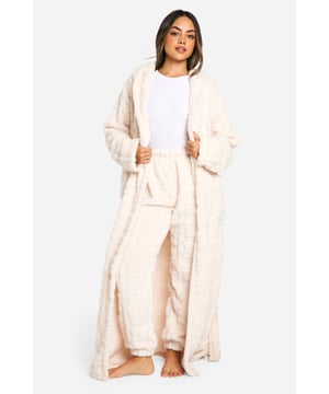 Cosy fleece fabric for ultimate comfort
        Embossed bear print design adds a playful touch
        Full-length style for complete coverage
        Belted waist for a customisable fit
        Spacious pockets for practicality
    
    Wrap yourself in luxurious comfort with this charming embossed bear print dressing gown. Perfect for lazy mornings or cosy nights in, this full-length robe is crafted from soft fleece fabric that will keep you warm and snug. The belted waist allows you to adjust the fit to your liking, while the spacious pockets are ideal for keeping your hands warm or storing small essentials. Style it over your favourite pyjama set for a complete loungewear look, or throw it on over a nightie for a quick dash to answer the door. Whether you're enjoying a cup of tea on the sofa or getting ready for bed, this dressing gown is the ultimate companion for your downtime moments. It's the perfect blend of style and comfort, making it an essential addition to your nightwear collection.