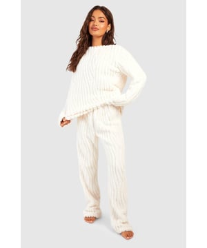 Cosy fleece fabric for ultimate comfort
        Stylish zebra stripe pattern throughout
        Relaxed fit jumper with ribbed cuffs and hem
        Matching wide-leg trousers for a coordinated look
        Versatile two-piece set for effortless loungewear
    
    Embrace the wild side of comfort with this striking zebra fleece jumper and trouser set from Boohoo. Perfect for those lazy days at home or cosy nights in, this ensemble offers both style and warmth. The relaxed fit jumper features ribbed cuffs and hem, ensuring a snug fit while maintaining a laid-back vibe. Paired with wide-leg trousers, the set creates a cohesive and trendy silhouette. Whether you're binge-watching your favourite series or hosting a casual gathering with friends, this set is your go-to for effortless chic. Layer with a longline cardigan for added warmth, or style the pieces separately to create multiple looks. The zebra pattern adds a playful touch to your loungewear collection, making it a standout choice for the fashion-forward woman who values both comfort and style in her at-home attire.