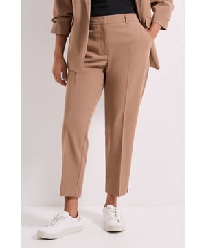 Sleek ankle grazer trousers with a flattering tailored fit
        Clean front seam detail for a polished silhouette
        Functional side pockets for practicality
        Versatile mid-rise waistband with belt loops
        Cropped length perfect for showcasing footwear
    
    These Dorothy Perkins ankle grazer trousers offer the perfect balance of comfort and style for the modern woman. The cropped length creates a contemporary silhouette that works beautifully with both casual and smart-casual ensembles. Style them as shown with a matching blazer and simple top for a coordinated look that transitions effortlessly from office to weekend brunch. The clean lines and tailored fit make these trousers incredibly versatile - pair with white trainers for relaxed daytime wear or dress them up with block heels for family gatherings. The woven fabric provides structure while maintaining comfort throughout the day. These trousers are a wardrobe essential that can be styled year-round, offering endless outfit possibilities while maintaining a refined yet approachable aesthetic that Dorothy Perkins customers love.