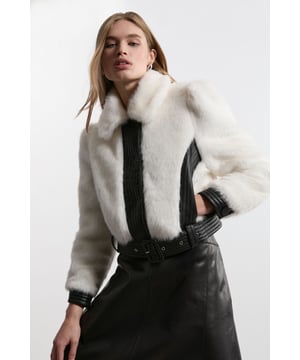 Feel elevated no matter the weather in our petite cropped jacket, made in high quality, thick faux fur, contrasted with sleek faux leather detailing. Wear it over any outfit, whether heading out for dinner or to the office. Petite Faux Fur Pu Panelled Belted Cropped Jacket High Quality, Thick Faux Fur Fabric Flattering Relaxed Fit Belted Waistline Contrasting Faux Leather Detailing Cropped Length Warm, Wide Collar Expertly designed for those 5'3" and under, our Petite pieces are perfectly proportioned for a smaller frame using shorter lengths.