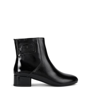 This Kurt Geiger Block Heeled Ankle Boot is crafted from a black patent leather. The heel is in a block style and there is a black metal patch on the outer side of the ankle. Heel height: 4cm.