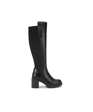 This Carvela Boulder High Leg boot is crafted from a soft black leather alternative. There is a soft elasticated panel along the back of the boot. The heel is in a block style. Heel height: 7.5cm.