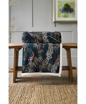 Add a touch of elegance and warmth to your home with this beautifully designed throw, featuring an intricate peacock and foliage print in rich shades of teal, blush, and gold. Crafted from luxuriously soft fleece with a plush sherpa reverse, it combines style with cosy comfort. Generously sized at 140 x 180cm, it’s perfect for draping over a sofa, layering on a bed, or wrapping around yourself on a chilly evening.