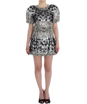 Dolce & Gabbana Exclusive Masterpiece Dress
  Brand new with tags
  Norman Knight inspired design
  Hand
  sewn crystal and sequined embellishments
  Cap sleeves and above knee length
  Full back zipper closure
  Made in Italy
  Stretch silk inner lining
  Logo engraved detailing
  One
  of
  a
  kind and rare
  Material: 30% Metal 28% Glass 25% Cotton 5% Silk 5% Acetate 5% Nylon 2% Polyester
  Lining: 96% Silk 4% Elastane