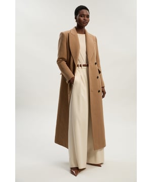 This Karen Millen tailored maxi coat offers the perfect balance of sophistication and practicality for your autumn-winter wardrobe. The structured silhouette creates a refined look whilst the wool blend fabric provides essential warmth for cooler days. Style with wide-leg trousers and a roll neck jumper for an effortlessly stylish daytime ensemble. The timeless design ensures this coat will remain a wardrobe staple for years to come, making it an investment piece that transcends seasonal trends whilst delivering on both style and function.  Wool blend maxi coat with a tailored fit Classic collared neckline with notched lapels Structured shoulders and defined waistline create a flattering shape Practical front pockets Full-length design