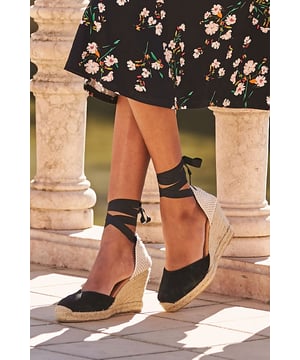 Summer in shoe formClassic espadrille with a luxe twistButter-soft suede in a go-with-everything shadeLuxe ribbon tieWear-all-day comfortable wedgeStyle with denim shorts dresses cropped trousers or midi skirtsWe recommend sizing up as this product runs small