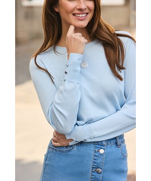 Knitwear you'll never want to take offLightweight but oh-so-cosy Cut to a classic crew neck silhouette Elevated with a luxe gold button detail Pastel blue hue looks dreamy with white denim Tuck it into tailoring for 9-5 style