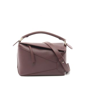 Structured handbag design
  Features a top handle
  Includes detachable shoulder strap
  Leather material