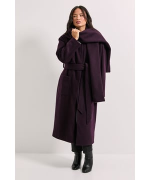Dramatic oversized scarf collar that can be styled multiple ways for versatile looks
        Longline silhouette with a flattering belted waist to define your shape
        Practical side pockets perfect for keeping essentials close at hand
        Clean round neckline design that works beautifully with various necklines underneath
        Relaxed regular fit allowing comfortable layering over winter outfits
    
    Make a statement this season with our Belted Round Neck Scarf Coat from Dorothy Perkins. The standout oversized scarf detail adds drama whilst providing extra warmth on chilly days. Style this versatile coat with slim-fit trousers and ankle boots for a polished daytime look, as seen on our model. The adjustable belt creates a feminine silhouette that works wonderfully for casual brunches with friends or family gatherings. The generous cut allows for comfortable layering over jumpers and cardigans without feeling restricted. This coat transitions effortlessly from weekend shopping trips to baby showers - simply pair with your favourite jeans and a soft knit for an ensemble that's both practical and stylish. Perfect for the woman who appreciates contemporary design with everyday wearability.