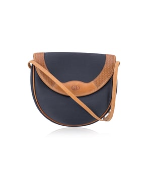 VINTAGE, RRP AS NEW
A timeless piece from the house of Dior, this vintage Christian Dior shoulder bag is a refined blend of Parisian elegance and understated luxury. Crafted in black canvas with tan leather trim, it carries the effortless charm of a bygone fashion era.  The front flap closes with magnetic button closure and is adorned with an engraved CD logo and small CD logos, a subtle nod to Dior's legacy, and fastens with a magnetic button closure for both style and ease. Inside, a soft beige lining complements the exterior's muted tones, while a 'Christian Dior - Made in France' tag ates its heritage. Leather shoulder strap.  Elegant, versatile, and collectible, this Dior piece is a must-have for vintage lovers and those who appreciate classic French craftsmanship.  Condition Rating: B - VERY GOOD CONDITIONCondition Details: Gently used. Some wear of use on leather trim and shoulder strap. Please see the photos and/or ask if you need further information or if you have any doubts.Measurements (cm):Depth: 5.1Height: 19.1Length: 20.3Other Details: Dustbag? NoKeys? NoBox? No Measurments:  width: 51 mm length: 203 mm height: 191 mm strap length: 0 mm handle drop: 0 mm