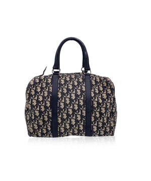 VINTAGE, RRP AS NEW
Step back into timeless Parisian elegance with this vintage Christian Dior Boston Bag, a classic silhouette reimagined in the house’s signature blue ‘Diorissimo’ monogram canvas. Trimmed in genuine leather, this structured travel companion exudes quiet luxury, reminiscent of the golden age of jet-set glamour. The top features a full-length zipper closure, opening to reveal a clean beige canvas lining with a single side zip pocket — the perfect blend of practicality and style. Inside, a ‘CHRISTIAN DIOR Bagages - Made in France’ label proudly nods to the bag’s heritage, evoking Dior’s legacy of refined craftsmanship and travel-inspired design. Whether for weekend escapes or everyday elegance, this Boston bag is a beautiful relic of Dior’s enduring sophistication.   Condition Rating: B - VERY GOOD CONDITIONCondition Details: Gently used. Minimal scratches on leather trim. Some light stains on the internal lining. Please see the photos and/or ask if you need further information or if you have any doubts.Measurements (cm):Depth: 15.2Height: 19.1Length: 27.9Other Details: Dustbag? NoKeys? NoBox? No Measurments:  width: 152 mm length: 279 mm height: 191 mm strap length: 0 mm handle drop: 0 mm