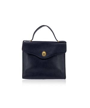VINTAGE, RRP AS NEW
With its elegant trapeze silhouette and warm light brown leather, this vintage Christian Dior handbag is a true gem for collectors who adore the quiet sophistication of classic Dior. Designed to offer both structure and versatility, it's a timeless companion that balances form and function with ease.  This bag features a top handle for ladylike carry. The front flap, secured with a button closure, is graced with an understated oval 'CD' tab, a subtle yet iconic nod to the house's legacy.  Inside, the bag is lined with care and fitted with a side zip pocket and a side open pocket to keep your essentials neatly tucked away. The inner 'Christian Dior - Made in France' tag confirms its ity and proudly speaks to its origin in the heart of Parisian craftsmanship.  Chic, structured, and unmistakably Dior, this vintage piece is a timeless treasure for those who appreciate fashion with a story and the enduring elegance of French design. Condition Rating: B - VERY GOOD CONDITIONCondition Details: Gently used. Some normal wear of use on leather due to normal use. Some normal wear of use inside. The bag originally comes with a removable shoulder strap, but unfortunately it is missing. Please check the photos carefully and ask if you need to know more details or if you have any doubts.Measurements (cm):Depth: 7.6Height: 20.3Length: 24.1Other Details: Dustbag? NoKeys? NoBox? No Measurments:  width: 76 mm length: 241 mm height: 203 mm strap length: 0 mm handle drop: 0 mm
