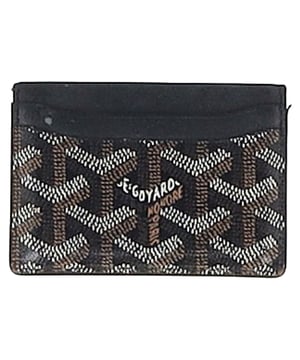 VINTAGE, RRP AS NEW
 The Goyard Saint-Sulpice Card Holder in black coated canvas is the ultimate accessory for the modern man who values both luxury and functionality. Crafted from Goyard's signature durable, coated canvas, this sleek card holder features a minimalist design with a subtle, embossed logo. With multiple card slots and a slim profile, it offers ample space for your essentials while maintaining a sophisticated, understated aesthetic.

Styling Tip:
Keep your look sharp by pairing this sleek card holder with a tailored suit for a polished, professional vibe. For a more casual outfit, pair it with slim-fit jeans and a leather jacket for an effortlessly stylish look. The black coated canvas complements any wardrobe, making the Goyard Saint-Sulpice Card Holder a versatile, luxury accessory that adds a touch of refinement to both everyday and formal attire.

Goyard Saint-Sulpice Card Holder in Black Coated Canvas

Condition: Excellent
Signs of wear:  No sign of wear.
Packaging: None
Color: Black
Material: Coated canvas
Size: One size
Measurements: 
SKU: MRPPUGBOT457326M