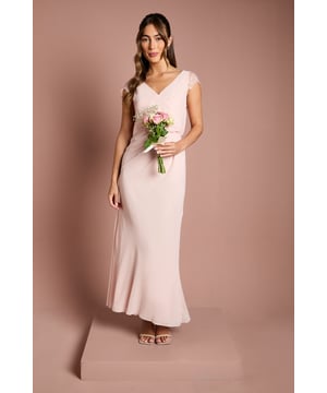 Elegant georgette maxi dress with delicate lace cap sleeves for a touch of romance
        Flattering wrap effect bodice creates a feminine silhouette
        Sophisticated V-neckline complemented by an equally elegant V-back with lace detailing
        Floor-sweeping maxi length with gentle flare for graceful movement
        Subtle gathering at the waist enhances the figure whilst ensuring all-day comfort
    
    This exquisite bridesmaids dress from Coast combines timeless elegance with contemporary design. The flowing georgette fabric drapes beautifully, whilst the wrap effect bodice creates a universally flattering shape that celebrates the feminine form. Delicate lace detailing on the cap sleeves and back adds a romantic touch perfect for wedding celebrations. Style with metallic strappy heels and a simple bracelet to maintain the dress's sophisticated aesthetic. For a coordinated bridal party look, this versatile design works beautifully in matching tones or complementary colour palettes. The understated elegance of this gown ensures you'll support the bride with grace and poise, whilst the comfortable fit means you can dance the night away at the reception. A truly special piece that honours your role in the bridal party.