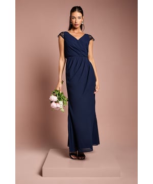 Elegant georgette maxi dress with delicate lace cap sleeves for a touch of romance
        Flattering wrap effect bodice creates a feminine silhouette
        Sophisticated V-neckline complemented by an equally elegant V-back with lace detailing
        Floor-sweeping maxi length with gentle flare for graceful movement
        Subtle gathering at the waist enhances the figure whilst ensuring all-day comfort
    
    This exquisite bridesmaids dress from Coast combines timeless elegance with contemporary design. The flowing georgette fabric drapes beautifully, whilst the wrap effect bodice creates a universally flattering shape that celebrates the feminine form. Delicate lace detailing on the cap sleeves and back adds a romantic touch perfect for wedding celebrations. Style with metallic strappy heels and a simple bracelet to maintain the dress's sophisticated aesthetic. For a coordinated bridal party look, this versatile design works beautifully in matching tones or complementary colour palettes. The understated elegance of this gown ensures you'll support the bride with grace and poise, whilst the comfortable fit means you can dance the night away at the reception. A truly special piece that honours your role in the bridal party.