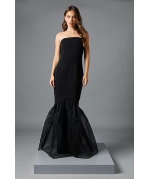 Strapless bandeau neckline for a sophisticated, clean silhouette
        Fitted bodice and waist that contours to your figure
        Dramatic fishtail hem with luxurious tulle detailing
        Floor-sweeping maxi length perfect for formal occasions
        Sleek back design that complements the structured front
    
    This striking strapless maxi dress commands attention with its architectural silhouette and dramatic fishtail hem. The fitted bodice gracefully hugs your curves before cascading into a show-stopping tulle skirt that creates mesmerising movement with every step. Style with statement earrings, as shown on our model, to frame your dcolletage beautifully. For race day events, pair with an ornate fascinator and strappy heels, whilst wedding guests might opt for a structured clutch and delicate bracelet. The versatile design transitions effortlessly from daytime ceremonies to evening receptions. This Coast creation embodies timeless elegance whilst offering contemporary drama - a true investment piece for your occasion wardrobe that will draw admiring glances across any sophisticated venue.
