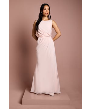 Elegant boat neckline creates a sophisticated silhouette perfect for bridal party ensembles
        Luxurious satin georgette fabric drapes beautifully for a graceful, flowing effect
        Stunning lace back detail adds a romantic touch with delicate scalloped edges
        Floor-sweeping maxi length offers timeless bridal party elegance
        Gathered waist design creates a flattering shape whilst maintaining comfort throughout the celebration
    
    This exquisite Coast bridesmaids dress combines classic elegance with contemporary detailing, making it the perfect choice for your bridal party. The refined boat neckline frames the dcolletage beautifully, whilst the flowing maxi silhouette creates a graceful presence as you move down the aisle. The showstopping feature is undoubtedly the intricate lace back detailing, offering a romantic contrast to the smooth satin georgette fabric. Style with delicate drop earrings and an elegant updo to showcase the beautiful back detail. For a coordinated bridal party look, this dress works wonderfully in matching tones or complementary shades within your wedding colour palette. The gathered waist ensures comfort throughout the ceremony and reception, allowing bridesmaids to move with ease whilst maintaining that picture-perfect silhouette as they support the bride on her special day.