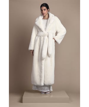Luxurious longline silhouette with sumptuous fur collar for dramatic flair
        Elegant belted design to cinch the waist and create a flattering shape
        Wide, relaxed sleeves for comfortable layering over occasion wear
        Soft fur trim detailing along the edges for a sophisticated finish
        Full-length cut offering maximum coverage and warmth for winter events
    
    Make a striking entrance at your next special occasion with this show-stopping longline fur coat from Coast. The dramatic floor-sweeping length creates an air of sophistication, whilst the plush fur collar frames your face beautifully. The accompanying belt allows you to customise your silhouette, whether worn loosely for a relaxed feel or cinched tightly for a more defined waist. Perfect for winter weddings and formal gatherings, this coat pairs wonderfully with floor-length gowns as shown, or can be styled with tailored trousers and heels for a chic evening ensemble. The generous cut allows for comfortable layering without compromising on style, making this a versatile investment piece for your occasion wardrobe. Complete your look with minimal jewellery and an elegant clutch to let this magnificent coat take centre stage.