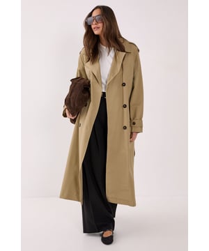 Layer up. Feel confident in our trench coat, with a classic longline design and a belted waistline. Pairs well with a casual fit for an elevated daytime look, or wear it over a mini dress for a levelled up night out look. Essentials Trench Coat Statement Wide Collar Belted Waist and Cuffs Iconic Longline Cut Button Front Fastenings Deep Pocket Accents Model wears a size M (US size 6/UK size 10).