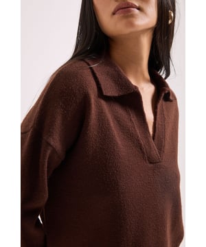 Stylish polo collar design with V-neck opening for a smart-casual aesthetic
        Knitted fabric provides warmth and comfort for everyday wear
        Relaxed fit with dropped shoulders for effortless styling
        Ribbed hem and cuffs add structure and definition to the silhouette
        Cropped length perfect for high-waisted bottoms
    
    This Petite Polo Collared Jumper from Dorothy Perkins offers the perfect blend of comfort and style for your casual wardrobe. The classic polo collar adds a refined touch to this knitted piece, whilst the V-neck opening creates a flattering neckline. Style with straight-leg jeans and ballet flats for weekend brunches with friends, or pair with a midi skirt and trainers for a sophisticated daytime look. The cropped length works beautifully with high-waisted trousers or skirts, creating a balanced silhouette that's particularly flattering for petite frames. Layer under a trench coat with a crossbody bag for autumn outings, or wear with tailored trousers for casual Fridays at the office. This versatile jumper transitions seamlessly from coffee dates to family gatherings, making it an essential addition to your daywear collection.