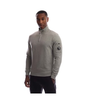 Mens C.P. Company Light Fleece Half Zip Sweatshirt in greystone melange.Half zip sweatshirt crafted in lightweight brushed fleece. The soft  breathable fabric ensures comfort and ease of movement.- Stand collar.- Hidden half zip fastening.- Pocket on left sleeve with iconic C.P. Company lens detail.- Ribbed cuffs and hem.- Garment dyed.- Regular fit.- 100% Cotton.  Machine washable.- Ref: 19CMSS102A 002246G M94