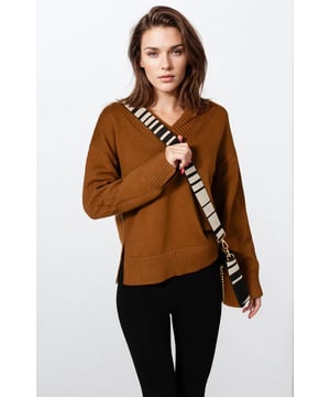 Stay stylish and cozy with this V-Neck Side Split Jumper. Crafted from thick knit fabric, it offers exceptional comfort and warmth. The side split design adds a flattering, modern edge, while cuff splits on the wrists enhance mobility and detail. Perfect for layering or wearing solo, this jumper blends fashion and function effortlessly.

24" Shoulder to Hem.
