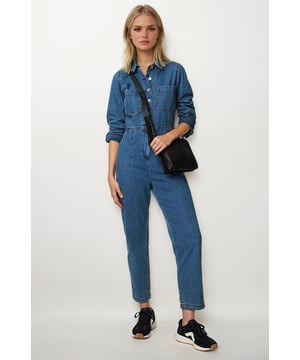 This denim long sleeve jumpsuit offers the perfect blend of style and functionality. With a button-up front and practical front and back pockets, it combines effortless fashion with everyday convenience. Its comfortable fit and timeless design make it an essential piece to elevate your wardrobe.

53" Shoulder to Hem.