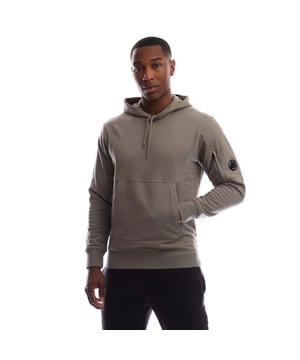 Mens C.P. Company Diagonal Raised Fleece Lens Hoodie in fungi grey.Hooded sweatshirt crafted in Diagonal Raised Fleece  a medium-weight brushed diagonal-weave cotton.  The soft fabric ensures comfort and ease of movement.  - Adjustable hood.- Kangaroo pocket.- Iconic Lens pocket at left sleeve.- Ribbed cuffs and hem.- Regular fit.- 100% Cotton.  Machine washable.- Ref: 19CMSS714A 005086W 356