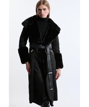 Feel elevated no matter the weather in our midi length coat, made in high quality, thick faux shearling, featuring a belted waist for a flattering fit, and a wide collar and midi length to protect from the cold weather. Wear it over any outfit, whether heading out for dinner or to the office. Faux Shearling Collar & Cuff Belted Midi Coat High Quality, Thick Faux Shearling Fabric Flattering Straight Silhouette Wide, Belted Waist for a Cinched Silhouette Pocket Features Warm, Wide Collar Midi LengthShop this seasons women's shearling coats and jackets or browse the full collection of coats and jackets now.