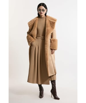 Feel elevated no matter the weather in our midi length coat, made in high quality, thick faux shearling, featuring a belted waist for a flattering fit, and a wide collar and midi length to protect from the cold weather. Wear it over any outfit, whether heading out for dinner or to the office. Faux Shearling Collar & Cuff Belted Midi Coat High Quality, Thick Faux Shearling Fabric Flattering Straight Silhouette Wide, Belted Waist for a Cinched Silhouette Pocket Features Warm, Wide Collar Midi LengthShop this seasons women's shearling coats and jackets or browse the full collection of coats and jackets now.