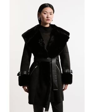 Feel elevated no matter the weather in our coat, made in high quality, thick faux shearling, featuring a belted waist for a flattering fit, and a wide collar and midi length to protect from the cold weather. Wear it over any outfit, whether heading out for dinner or to the office. Faux Shearling Collar & Cuff Belted Short Coat High Quality, Thick Faux Shearling Fabric Flattering Straight Silhouette Wide, Belted Waist for a Cinched Silhouette Pocket Features Warm, Wide Collar Thigh Skimming LengthShop this seasons women's shearling coats and jackets or browse the full collection of coats and jackets now.