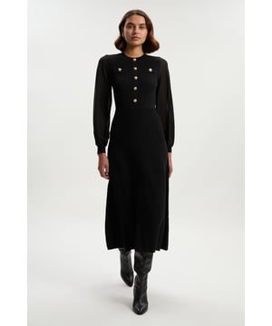 Experience elevated eveningwear in a knit dress, featuring a silhouette that skims the curves, and sheer, chiffon sleeves with a balloon cut for a playful edge. The metallic button details add contrast, and elevate this piece into a much more formal item, so pair it with heeled boots or strappy heels for all upcoming occasions and events. Viscose Blend Chiffon Sleeve Military Trim Knit Maxi Dress High Quality, Soft Knit Fabric Statement, Balloon Style Chiffon Sleeves Contrasting Metallic Military Buttons Flattering Fit and Flare SilhouetteDiscover this seasons knitted dresses or browse the full collection of women's dresses now.