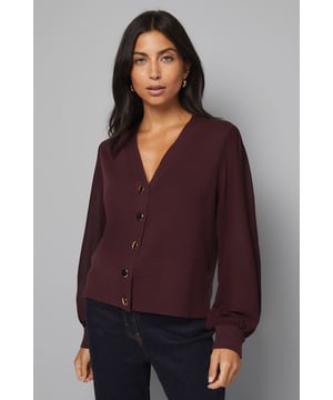 Elegant V-neckline with sophisticated button-front design
        Luxurious chiffon sleeves adding a touch of feminine flair
        Flattering cropped silhouette perfect for high-waisted bottoms
        Versatile knitted fabric offering comfort with a structured look
        Timeless design suitable for both casual and smart-casual occasions
    
    This exquisite Wallis cardigan combines the comfort of a knitted body with the sophistication of flowing chiffon sleeves for a truly distinctive look. The button-front design and V-neckline create a flattering silhouette that works beautifully with dark denim jeans and boots for everyday elegance. Style with tailored trousers and ballet flats for family gatherings, or pair with a midi skirt and statement earrings for more formal daytime events. The cropped length sits perfectly with high-waisted bottoms, creating a balanced silhouette. This cardigan transitions effortlessly from office to evening, making it a versatile addition to your wardrobe. For a complete look, add a structured tote bag as shown and minimal jewellery to maintain the cardigan's sophisticated appeal whilst ensuring comfort remains paramount.