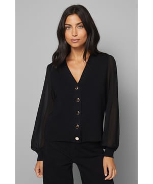 Elegant V-neckline with sophisticated button-front design
        Luxurious chiffon sleeves adding a touch of feminine flair
        Flattering cropped silhouette perfect for high-waisted bottoms
        Versatile knitted fabric offering comfort with a structured look
        Timeless design suitable for both casual and smart-casual occasions
    
    This exquisite Wallis cardigan combines the comfort of a knitted body with the sophistication of flowing chiffon sleeves for a truly distinctive look. The button-front design and V-neckline create a flattering silhouette that works beautifully with dark denim jeans and boots for everyday elegance. Style with tailored trousers and ballet flats for family gatherings, or pair with a midi skirt and statement earrings for more formal daytime events. The cropped length sits perfectly with high-waisted bottoms, creating a balanced silhouette. This cardigan transitions effortlessly from office to evening, making it a versatile addition to your wardrobe. For a complete look, add a structured tote bag as shown and minimal jewellery to maintain the cardigan's sophisticated appeal whilst ensuring comfort remains paramount.