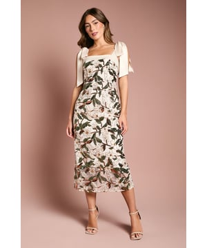 Elegant column midi dress adorned with intricate floral sequin embellishment
        Sophisticated square neckline framed by delicate satin shoulder ties
        Figure-flattering silhouette with a sleek column cut
        Refined back split detail for ease of movement
        Subtle satin trim detailing enhances the luxurious aesthetic
    
    Make a striking impression at your next special occasion with this exquisite Coast floral sequin midi dress. The column silhouette creates a graceful profile that celebrates your figure, whilst the square neckline offers a contemporary touch of sophistication. The charming satin shoulder ties add a romantic element that can be adjusted to your preference. Style with strappy heeled sandals and a clutch bag for weddings or race day events. For evening occasions, complement with statement earrings and a sleek updo to showcase the beautiful neckline. The versatile midi length works wonderfully for formal garden parties, graduation ceremonies or elegant dinner engagements. This dress captures Coast's signature occasion-wear excellence, promising to become a treasured piece for your most memorable moments.