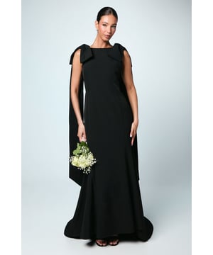 Elegant boat neckline with striking bow detail at the shoulders
        Sophisticated column silhouette that creates a sleek, statuesque profile
        Floor-sweeping maxi length perfect for formal wedding celebrations
        Dramatic button-back detail adding interest and refinement
        Flowing crepe fabric that drapes beautifully for all-day comfort
    
    This stunning bridesmaid dress from Coast combines timeless elegance with contemporary design elements. The refined column silhouette creates a graceful, elongated figure whilst the distinctive bow details at the shoulders add a touch of drama and sophistication. The boat neckline frames the dcolletage beautifully, whilst the button-back detail offers a classic finishing touch. Style with delicate strappy heels and a sleek updo to showcase the elegant neckline. For wedding celebrations, complement with subtle jewellery that won't compete with the dress's architectural details. This bridesmaid gown is designed to harmonise perfectly within a coordinated bridal party whilst ensuring each attendant feels confident and poised throughout the celebration. The flowing crepe fabric moves gracefully as you walk down the aisle, ensuring you look impeccable from every angle in the wedding photographs.