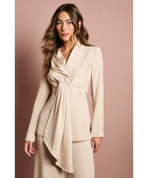 Elegant crepe blazer featuring a sophisticated drape front detail with luxurious satin trim
        Distinctive collared neckline creates a refined silhouette perfect for special occasions
        Flattering gathered waist design enhances your natural shape
        Long sleeves with structured shoulders for a polished, tailored appearance
        Versatile piece that transitions effortlessly from day to evening events
    
    Make a striking entrance at your next special occasion with this beautifully crafted Coast blazer. The standout drape front detail with satin trim creates a graceful cascade effect that adds movement and sophistication to your ensemble. Pair with the matching wide-leg trousers as shown for a contemporary take on occasion dressing that will turn heads at weddings, race days or graduation ceremonies. The structured shoulders and tailored fit create a flattering silhouette, whilst the crepe fabric offers a luxurious drape that moves elegantly with you. Complete your look with statement earrings and pointed heels for the ultimate in refined style. This versatile piece works beautifully as part of a coordinated set or can be styled with slim trousers and a camisole for a more relaxed yet equally chic approach to formal dressing.