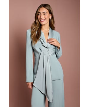 Elegant crepe blazer featuring a sophisticated drape front detail with luxurious satin trim
        Distinctive collared neckline creates a refined silhouette perfect for special occasions
        Flattering gathered waist design enhances your natural shape
        Long sleeves with structured shoulders for a polished, tailored appearance
        Versatile piece that transitions effortlessly from day to evening events
    
    Make a striking entrance at your next special occasion with this beautifully crafted Coast blazer. The standout drape front detail with satin trim creates a graceful cascade effect that adds movement and sophistication to your ensemble. Pair with the matching wide-leg trousers as shown for a contemporary take on occasion dressing that will turn heads at weddings, race days or graduation ceremonies. The structured shoulders and tailored fit create a flattering silhouette, whilst the crepe fabric offers a luxurious drape that moves elegantly with you. Complete your look with statement earrings and pointed heels for the ultimate in refined style. This versatile piece works beautifully as part of a coordinated set or can be styled with slim trousers and a camisole for a more relaxed yet equally chic approach to formal dressing.