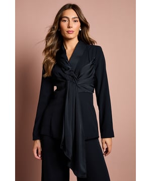 Elegant crepe blazer featuring a sophisticated drape front detail with luxurious satin trim
        Distinctive collared neckline creates a refined silhouette perfect for special occasions
        Flattering gathered waist design enhances your natural shape
        Long sleeves with structured shoulders for a polished, tailored appearance
        Versatile piece that transitions effortlessly from day to evening events
    
    Make a striking entrance at your next special occasion with this beautifully crafted Coast blazer. The standout drape front detail with satin trim creates a graceful cascade effect that adds movement and sophistication to your ensemble. Pair with the matching wide-leg trousers as shown for a contemporary take on occasion dressing that will turn heads at weddings, race days or graduation ceremonies. The structured shoulders and tailored fit create a flattering silhouette, whilst the crepe fabric offers a luxurious drape that moves elegantly with you. Complete your look with statement earrings and pointed heels for the ultimate in refined style. This versatile piece works beautifully as part of a coordinated set or can be styled with slim trousers and a camisole for a more relaxed yet equally chic approach to formal dressing.