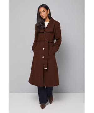 Elegant knitted collar for added sophistication
        Wrap design with button-through closure for versatile styling
        Long length offers maximum coverage and warmth
        Belted waist creates a flattering silhouette
        Functional side pockets for practicality
    
    This Wallis Knitted Collar Button Through Wrap Coat is the epitome of refined elegance. Perfect for the woman who appreciates sophistication without compromising on comfort, this coat is a versatile addition to any wardrobe. The wrap design allows for customisable fit, while the button-through closure adds a touch of classic charm. Style it over a sleek midi dress and pair with heeled boots for a polished look at formal events. For smart casual occasions, layer it over tailored trousers and a fine knit jumper, completing the ensemble with leather ankle boots. The long length and belted waist not only provide warmth but also create a striking silhouette that's sure to turn heads. Whether you're attending a business meeting or heading to a sophisticated dinner, this coat will ensure you look impeccably put-together while feeling effortlessly comfortable.