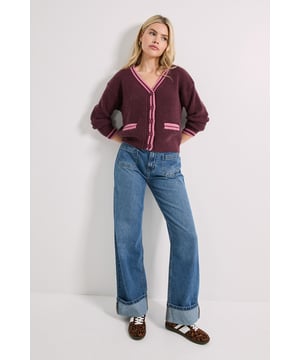 Stylish V-neck cardigan with distinctive cricket-inspired contrast trim
        Ribbed knit texture adds depth and visual interest to this casual piece
        Functional front pockets with contrasting trim detail for both style and practicality
        Button-through front closure for versatile styling options
        Relaxed fit with three-quarter length sleeves for year-round wearability
    
    This Contrast Cricket Cardigan from Dorothy Perkins brings a preppy twist to your casual wardrobe. The classic V-neckline and button-through design create a flattering silhouette, whilst the contrasting trim adds a playful touch to this otherwise understated piece. Style with wide-leg jeans and trainers for weekend brunches with the girls, or throw over a simple tee and straight-leg trousers for family gatherings. The ribbed texture provides warmth without bulk, making it perfect for transitional weather. For a coordinated daytime look, pair with a simple white tee, your favourite denim and flat loafers. This cardigan works brilliantly as a lightweight layer for coffee dates or casual shopping trips, offering both comfort and style for your everyday adventures.
