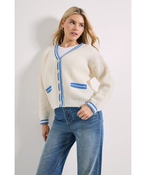 Chunky ribbed knit cardigan with distinctive cricket-inspired contrast trim
        V-neckline with button-through front for versatile styling options
        Practical front patch pocket with contrast detailing
        Relaxed, boxy silhouette perfect for effortless layering
        Contrast stripe detailing on cuffs for a sporty finishing touch
    
    This Dorothy Perkins Contrast Cricket Cardigan brings a playful twist to classic knitwear. The relaxed fit and ribbed texture create a cosy yet stylish layer that works beautifully for casual daywear. Style it as seen with straight-leg jeans and trainers for weekend brunches with the girls, or throw it over a simple t-shirt dress when meeting friends for coffee. The versatile V-neck design allows for layering over collared shirts for a preppy look that's perfect for family gatherings. The contrast trim adds a sporty element that nods to traditional cricket whites whilst maintaining a contemporary feel. This cardigan transitions effortlessly between seasons - wear open over a camisole during milder days or buttoned up with a scarf when the temperature drops. A wardrobe essential that combines comfort with just the right amount of character.