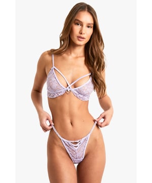 Delicate lace fabric for a romantic look
        Alluring cut-out design on the thong
        Adjustable shoulder straps for a customised fit
        Scalloped edges for a feminine touch
        Bow detail at centre front adds a playful accent
    
    Indulge in the allure of this captivating Valentine's Day-inspired lingerie set from Boohoo. The intricate lace fabric creates a delicate, see-through effect that's both tantalising and elegant. The bra features a unique cut-out design with criss-cross straps, adding a modern twist to classic lingerie. The matching thong showcases a daring cut-out detail, perfect for those who want to make a bold statement. This set is ideal for a romantic evening in or as a special surprise for your partner. Pair with your favourite silk robe for an added touch of luxury, or wear under a form-fitting dress for a confidence boost on a night out. Whether you're celebrating Valentine's Day or simply treating yourself, this lingerie set is sure to make you feel irresistible.
